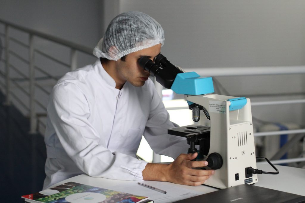Person Using Polyvinyl Alcohol on a Microscope Test